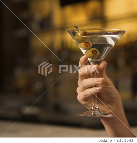Woman holding martini. 3351642