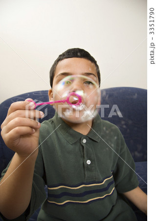 Boy blowing bubbles. Boy blowing bubbles. 3351790
