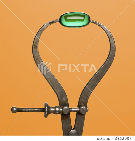 Green Capsule in Caliper. Isolated 3352007