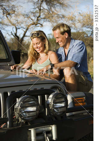 Couple With Map on Car Hood 3352537