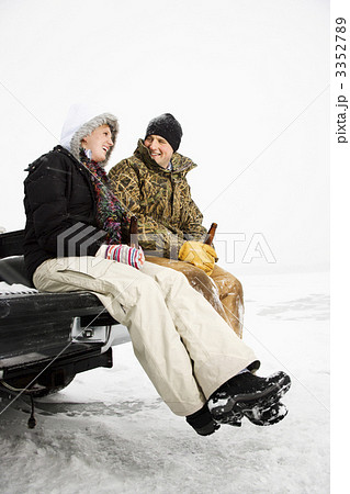 Young Couple Sitting on Truck Tailgate Young Couple Sitting on Truck Tailgate 3352789
