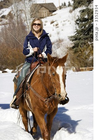 Woman horseback riding in snow. 3352934