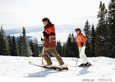 Couple Skiing on Mountain Slope Couple Skiing on Mountain Slope 3353171