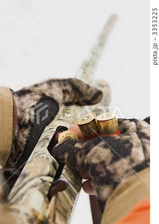 Hands loading shotgun. 3353225