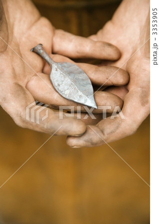 Metalsmith holding metal leaf. 3353905