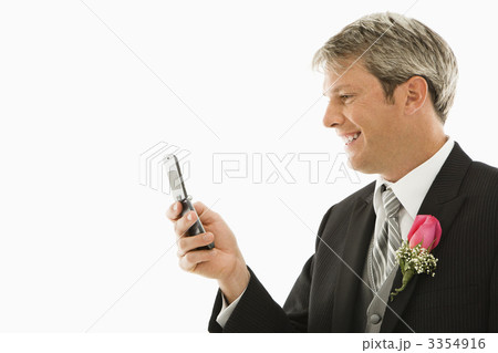 Groom using his cellphone. 3354916