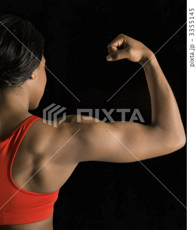 Woman flexing bicep. Woman flexing bicep. 3355145