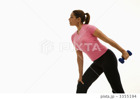Woman exercising with dumbbell. Woman exercising with dumbbell. 3355194