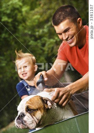 Family giving dog a bath. Family giving dog a bath. 3361107
