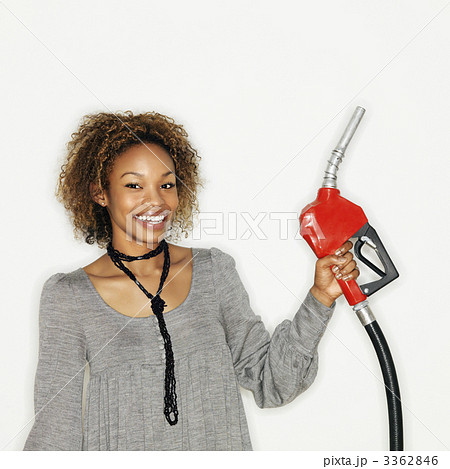 Woman holding gas nozzle 3362846