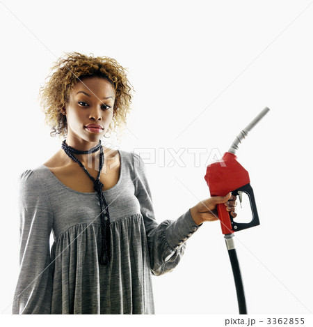 Woman holding gas nozzle Woman holding gas nozzle 3362855