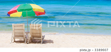 Panorama of tropical beach with chairs and umbrella 3389607