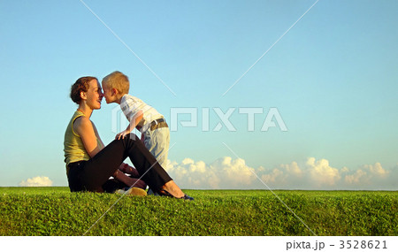 mother with son on sundown kiss by nose. long. 3528621