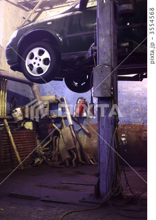 Car on lift in workshop Car on lift in workshop 3554568