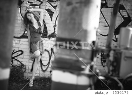 Young woman standing at the wall 3556175