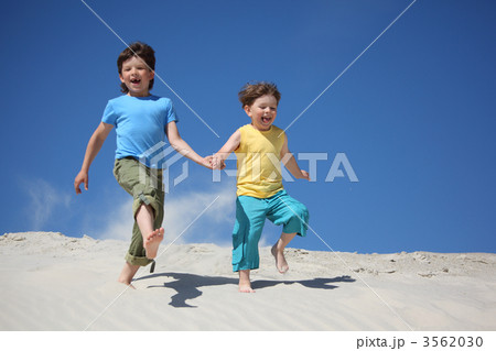 Two boys run on sand Two boys run on sand 3562030