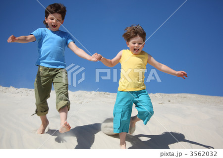 Two boys run on sand Two boys run on sand 3562032