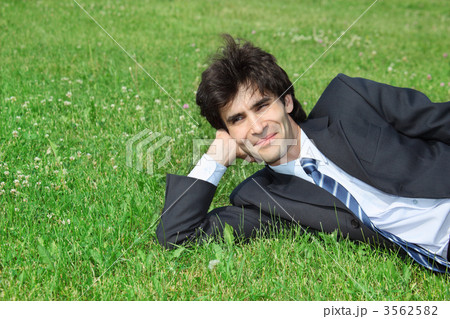 businessman has rest, lying on grass 3562582