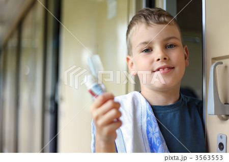 boy in wagon of train with tooth-paste and brush boy in wagon of train with tooth-paste and brush 3563553