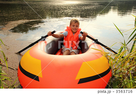 boy in inflatable boat in water 3563716
