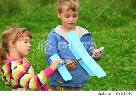 little girl and boy with toy airplane in hands outdoor 3563740