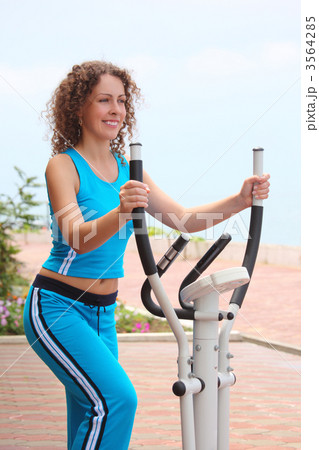 smiling girl on training apparatus outdoor 3564285