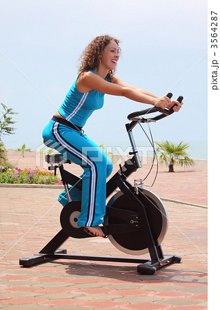 smiling girl on bicycle training apparatus outdoor 3564287