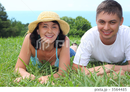 young couple lies on grass 3564485