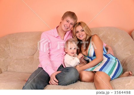 young family on sofa in pink room 2 young family on sofa in pink room 2 3564498