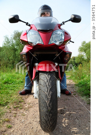 motorcyclist standing on country road, closeup, front view 3564751