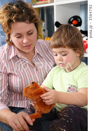 mother with child in playroom with soft toy mother with child in playroom with soft toy 3564792