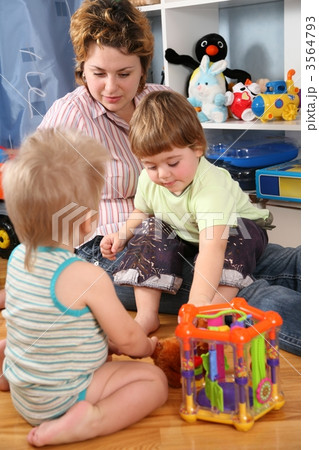 mother and two children in playroom mother and two children in playroom 3564793