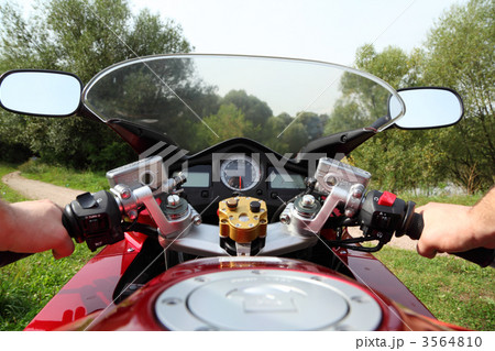 hands of motorcyclist  on country road 3564810