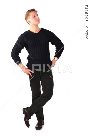 Young man stands cross legs Young man stands cross legs 3569982