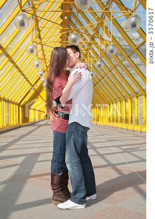 young pair kisses on footbridge 3570617
