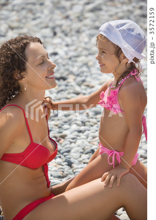young beautiful woman with pretty little girl in white hat on st young beautiful woman with pretty little girl in white hat on st 3572159