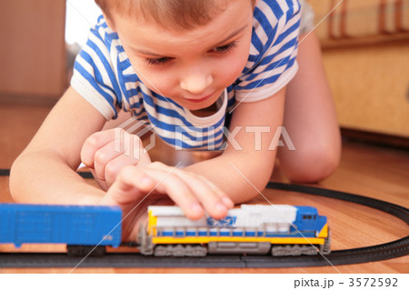 Boy playing with toy railroad 3572592