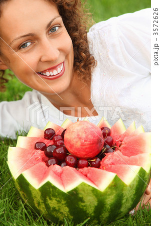 young beautiful woman with fruit lying on alawn young beautiful woman with fruit lying on alawn 3572626