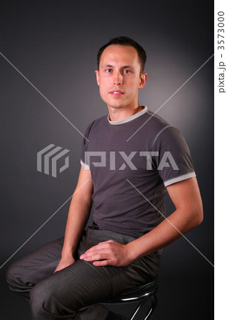 portrait of young man sits on stool portrait of young man sits on stool 3573000