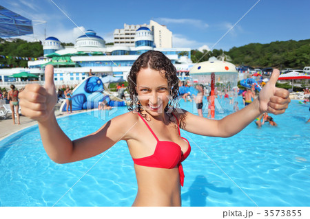 Smiling beautiful woman standing in pool of an entertaining comp 3573855