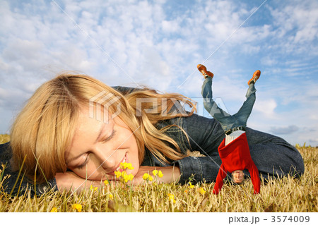 young woman lies on the grass and miniature boy on hands collage young woman lies on the grass and miniature boy on hands collage 3574009