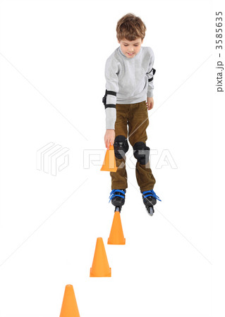little boy with cone in hand rollerblading near orange cones loo little boy with cone in hand rollerblading near orange cones loo 3585635