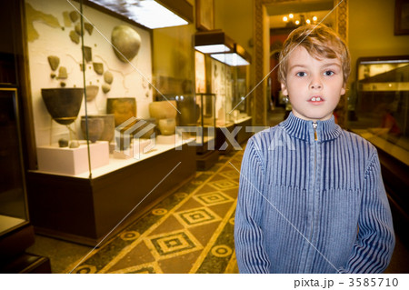 boy at excursion in historical museum near exhibits of ancient r boy at excursion in historical museum near exhibits of ancient r 3585710
