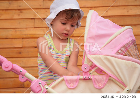 Girl with  children's carriage 3585768