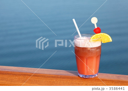 cocktail with fruits in glass on ship deck rail, sea on backgrou cocktail with fruits in glass on ship deck rail, sea on backgrou 3586441