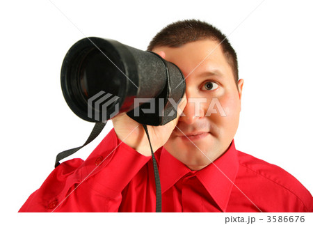 Businessman in red shirt looks in  spyglass 3586676