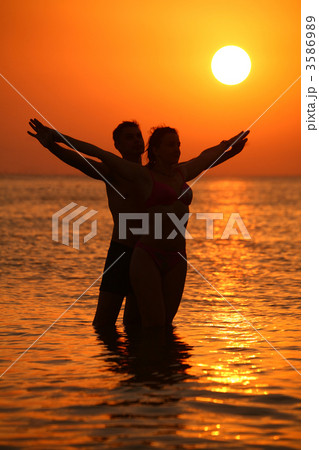 Couple in sea on sunset 3586989