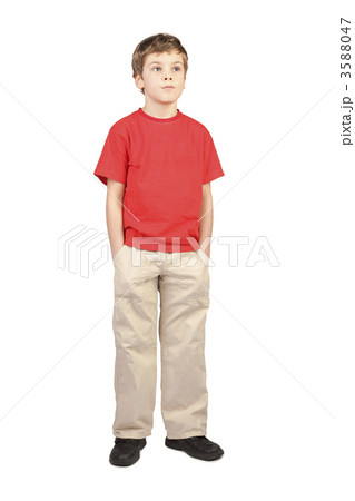 little boy in red shirt hands in pockets standing on white backg 3588047