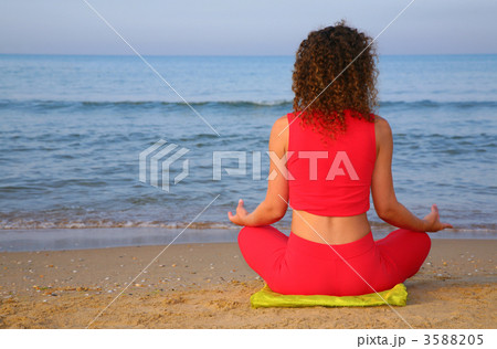 Yoga girl on beach from back 3588205