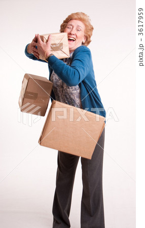 Senior woman with falling parcels Senior woman with falling parcels 3617959